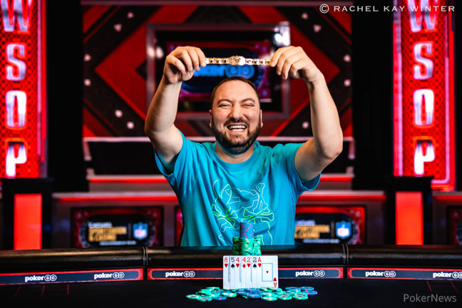 Nikolay Fal holds his bracelet aloft triumphantly after winning $1,500 7-card Stud